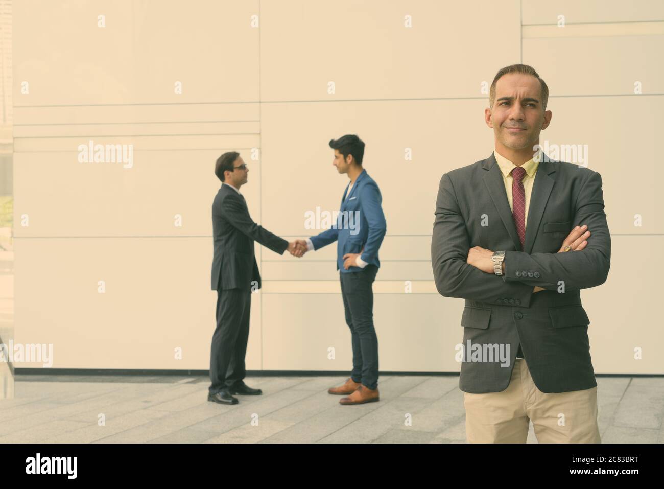 Portrait of Persian businessmen together in the city streets outdoors Stock Photo