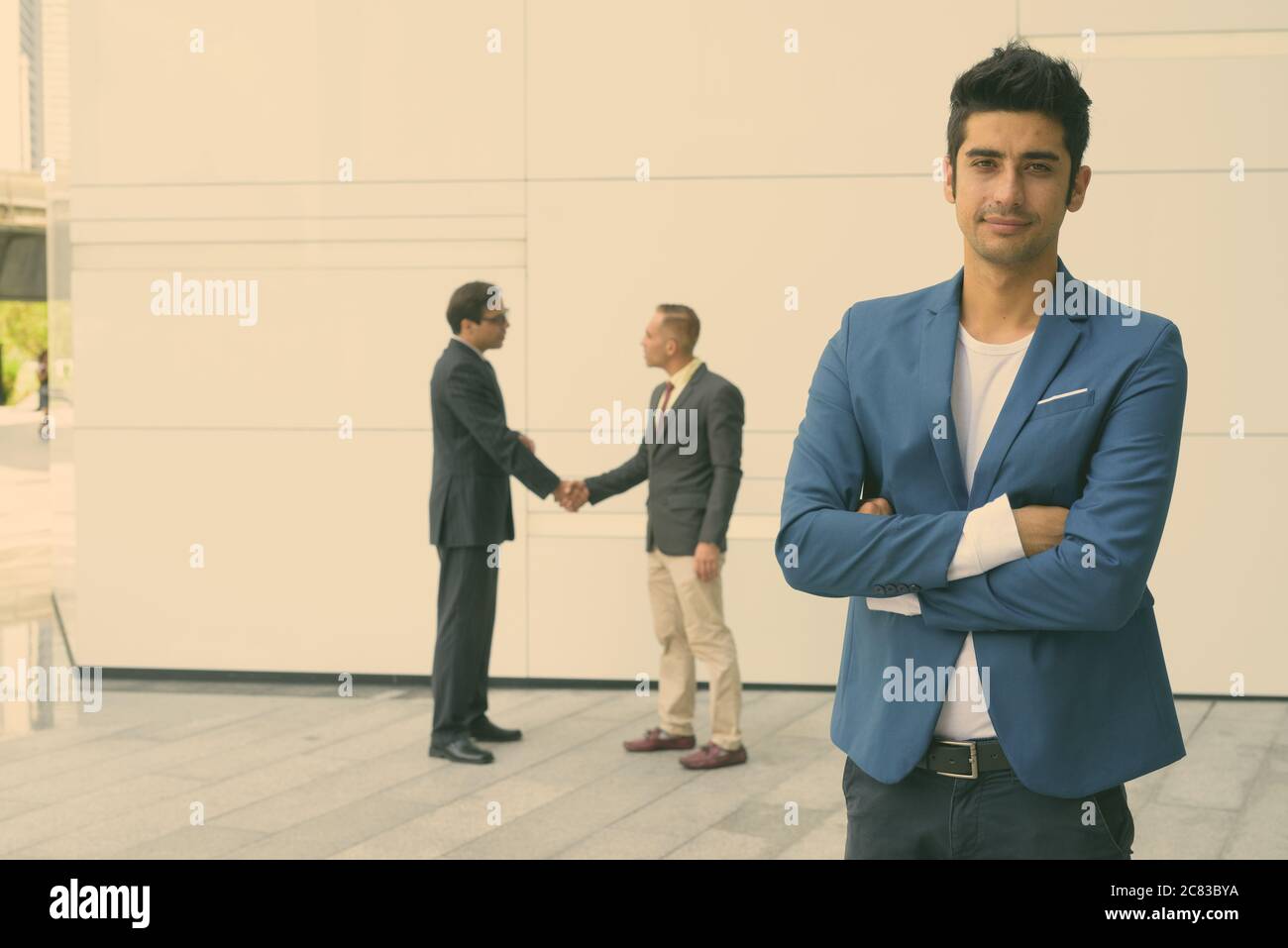 Portrait of Persian businessmen together in the city streets outdoors Stock Photo