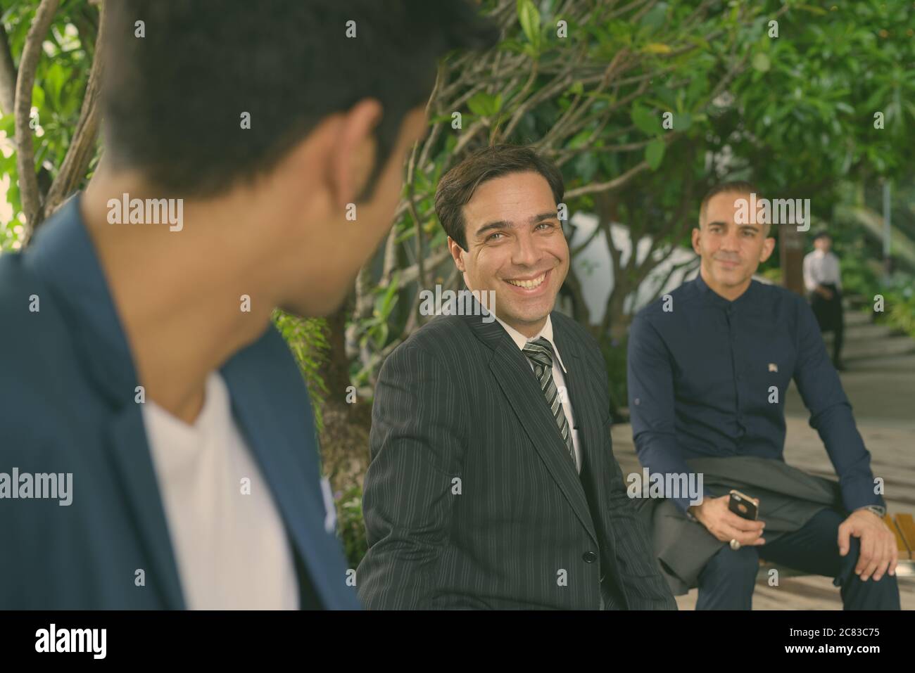 Portrait of Persian businessmen together at the park outdoors Stock Photo