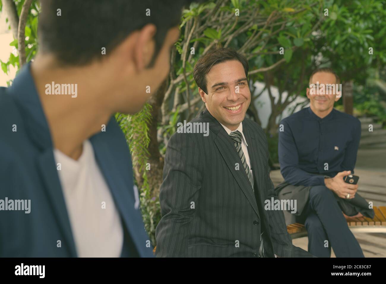 Portrait of Persian businessmen together at the park outdoors Stock Photo