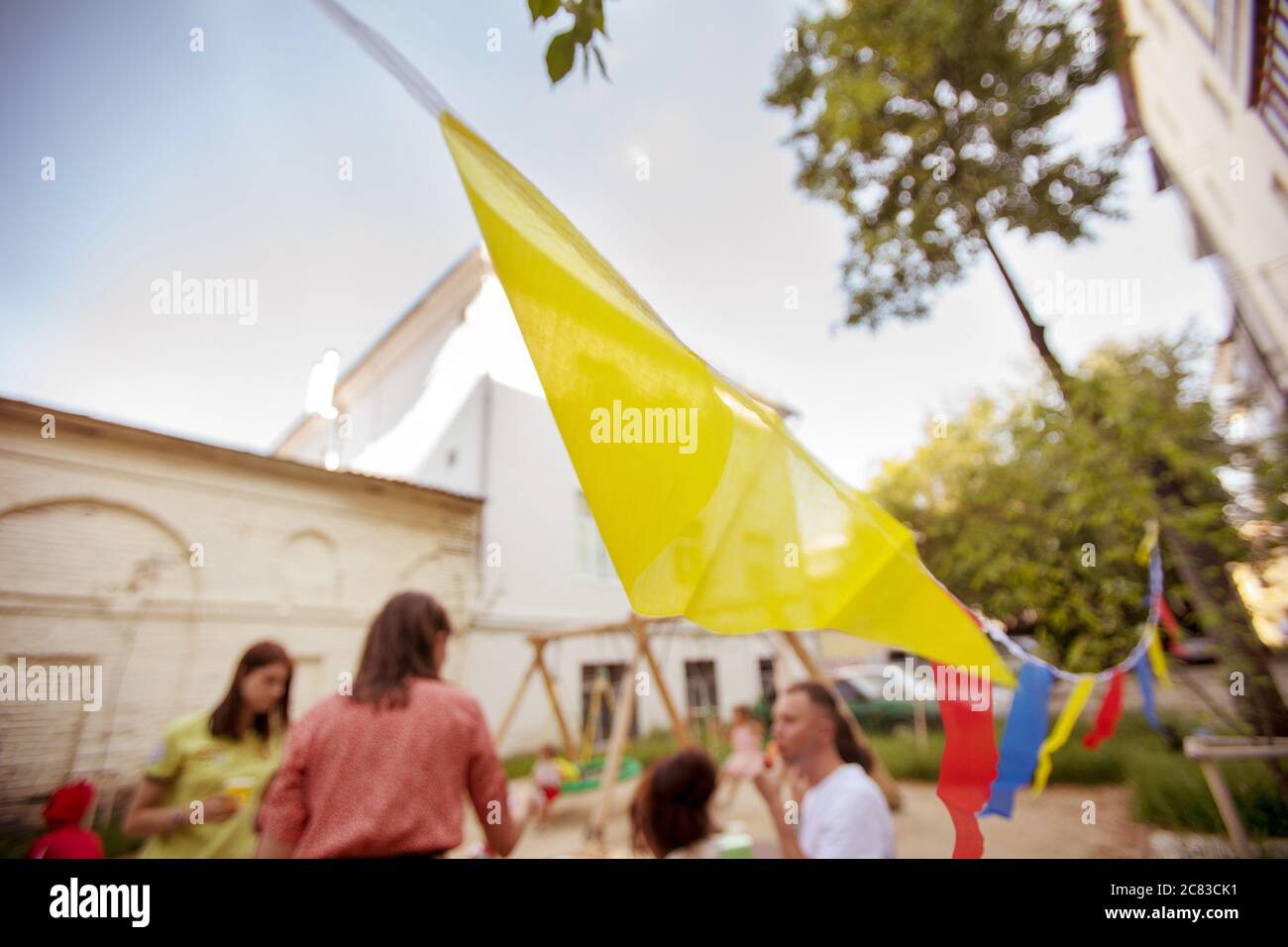 Friends having party on street with colorful flags Stock Photo