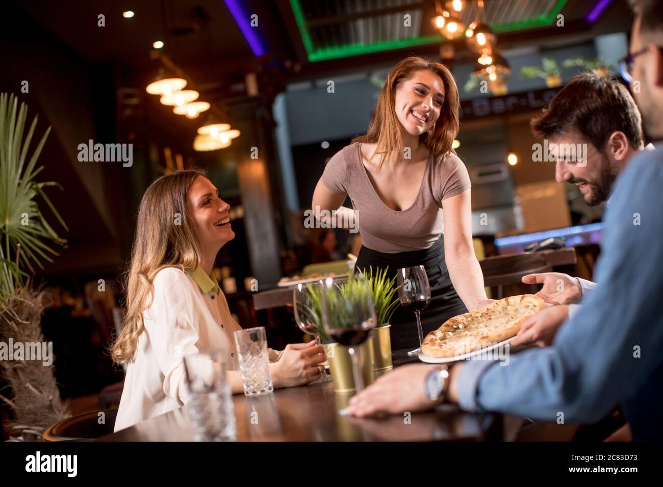 Waitress server adds adding cheese grinder hi-res stock photography and  images - Alamy