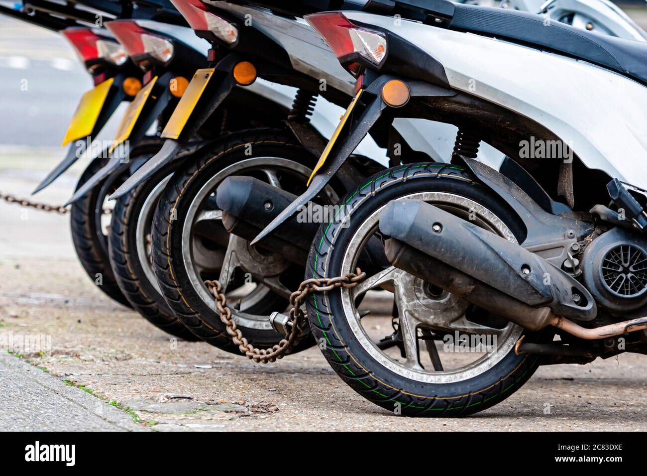 The rear wheels of the pizza delivery scooter chain are locked with an