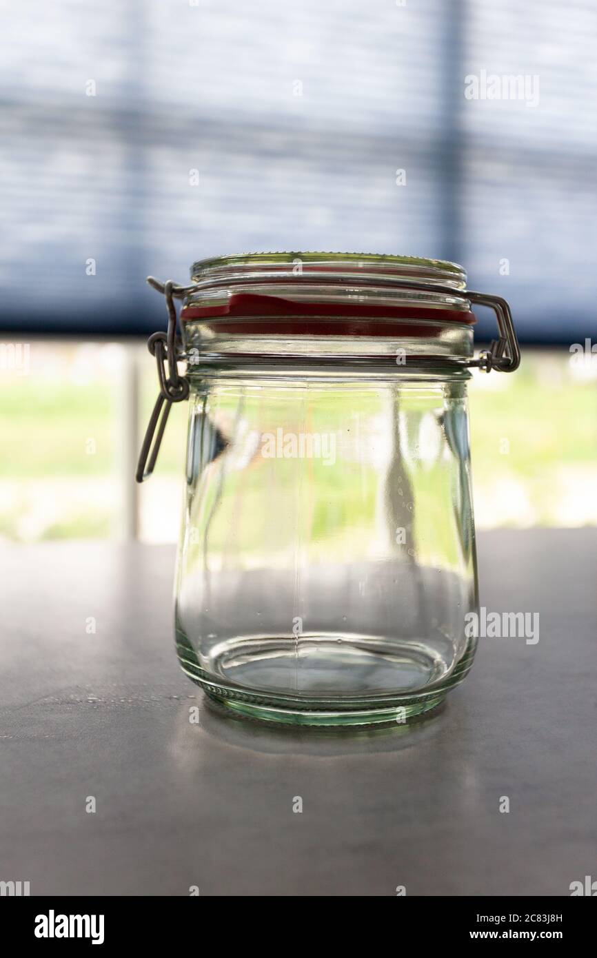 Closeup shot of a glass bank on a grey table Stock Photo