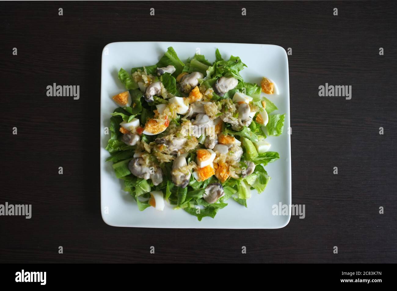 Spicy uncooked oyster with thai herbs . Seafood menu served at Thai restaurant. Stock Photo