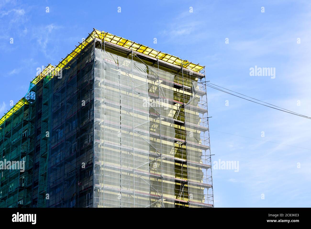 Image showcasing apartment house facade renovation and thermal insulation, scaffolding ...