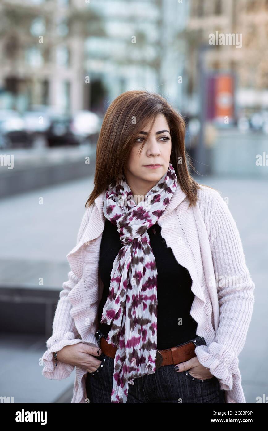 Serious Middle Eastern standing outdoors looking away Stock Photo