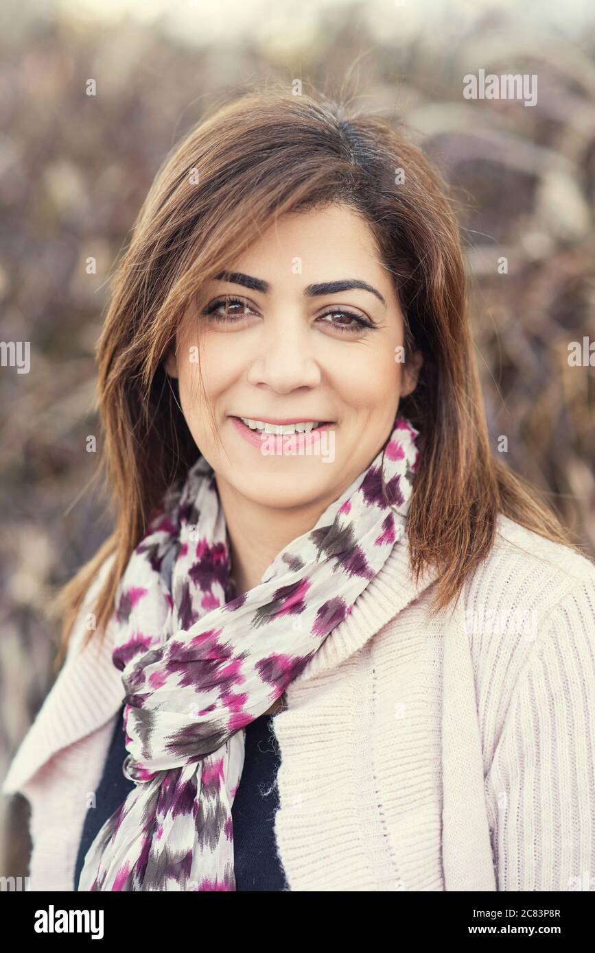 Happy middle eastern woman looking at camera smiling Stock Photo