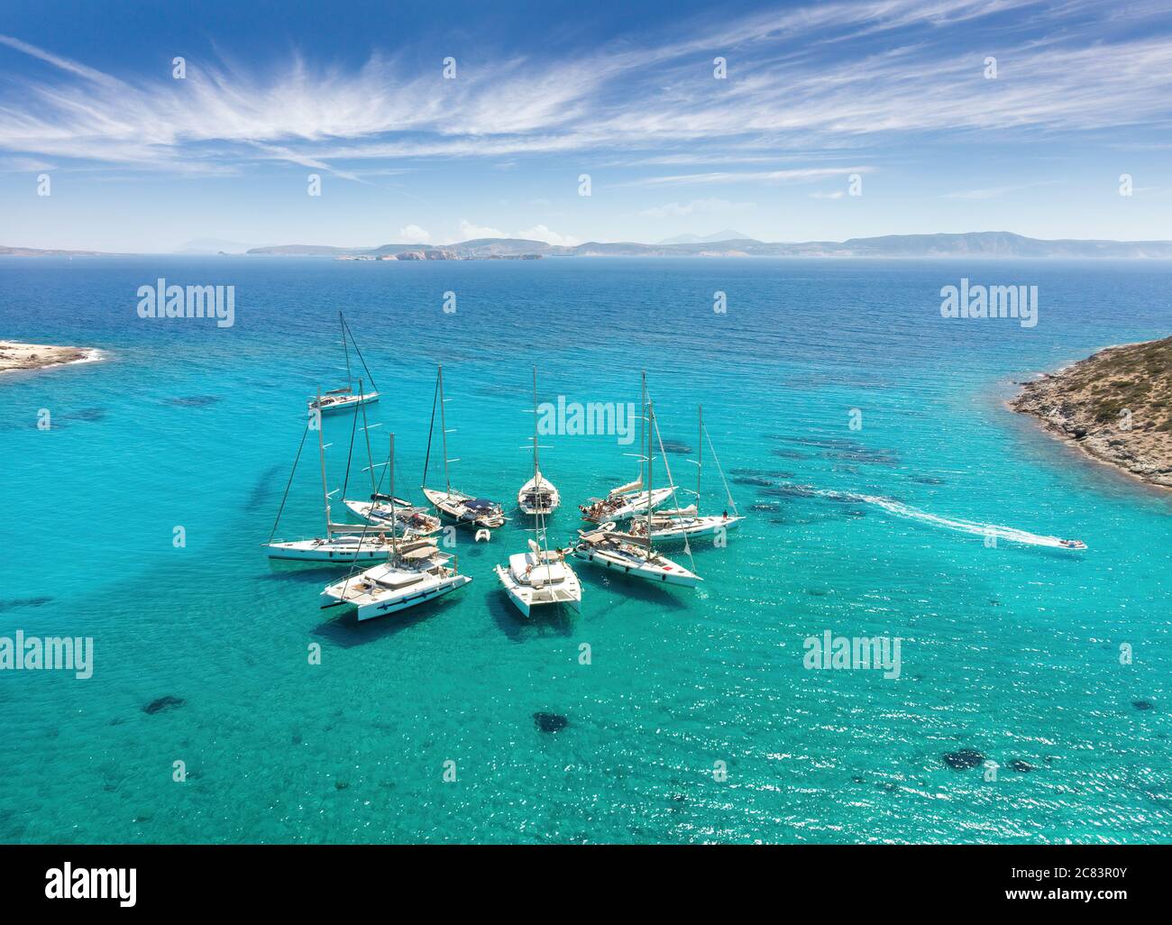 Aerial View of Sailing boats in star formation in Greece (Polyaigos, Cyclades) the largest uninhabited island of the Aegean Sea and one of the best an Stock Photo
