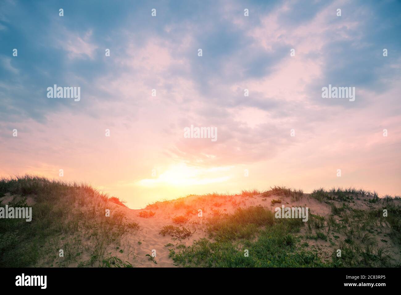 Sandy dune against evening sky. Nature landscape. Sandy hills on the beach Stock Photo