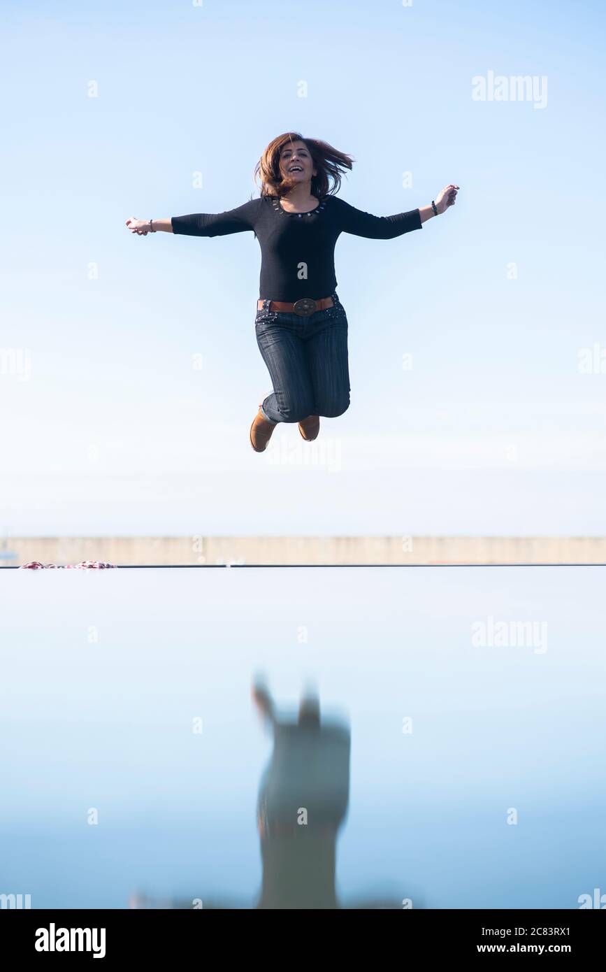 Happy woman jumping hi-res stock photography and images - Alamy