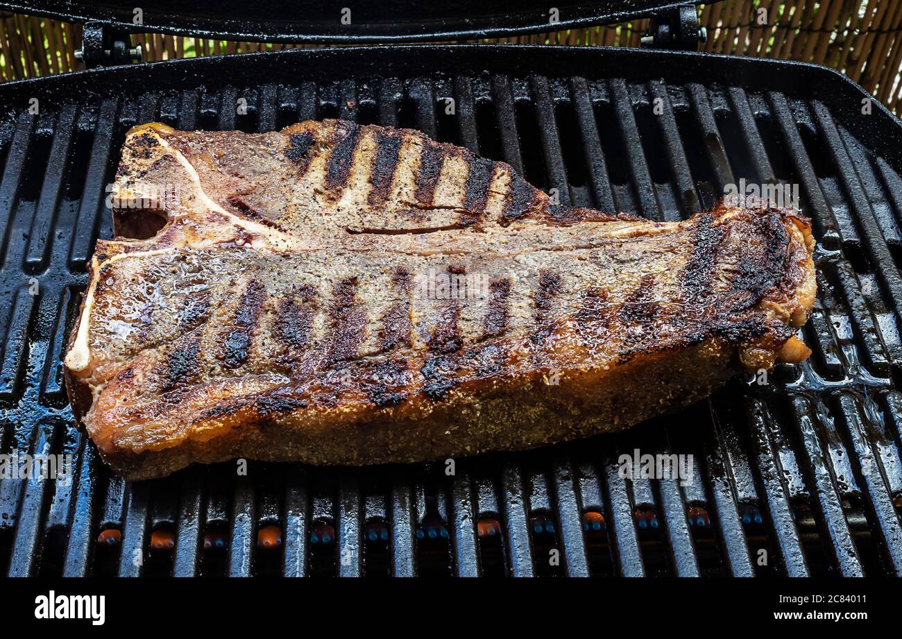 Medium thick tbone steak on barbecue grill Stock Photo Alamy