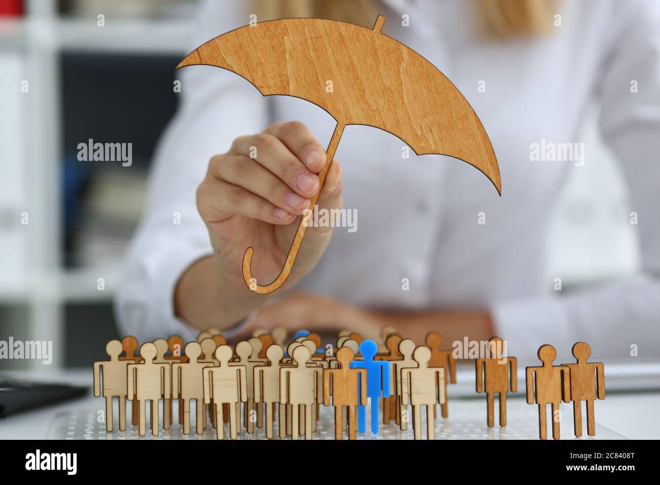 Businesswoman developing company strategy by using wooden figures Stock Photo