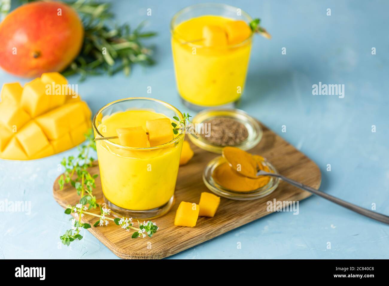 Yellow Indian mango yogurt drink Mango Lassi or smoothie with turmeric ...