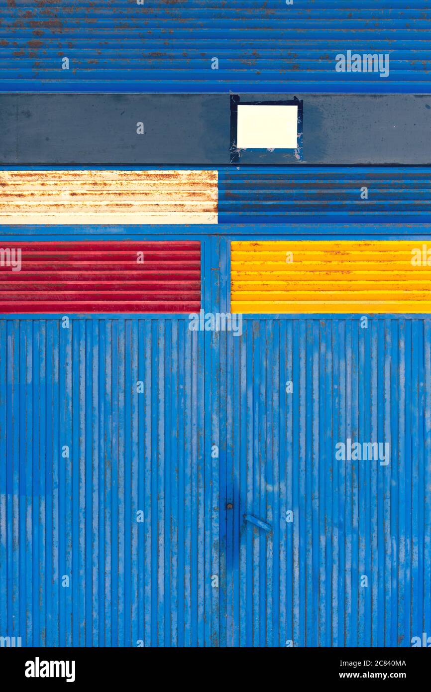 Iron metal gate with colored painted rectangles Stock Photo