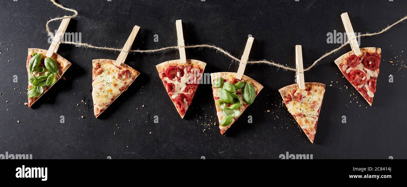 Panorama banner with slices of pizza with a variety sample toppings ...