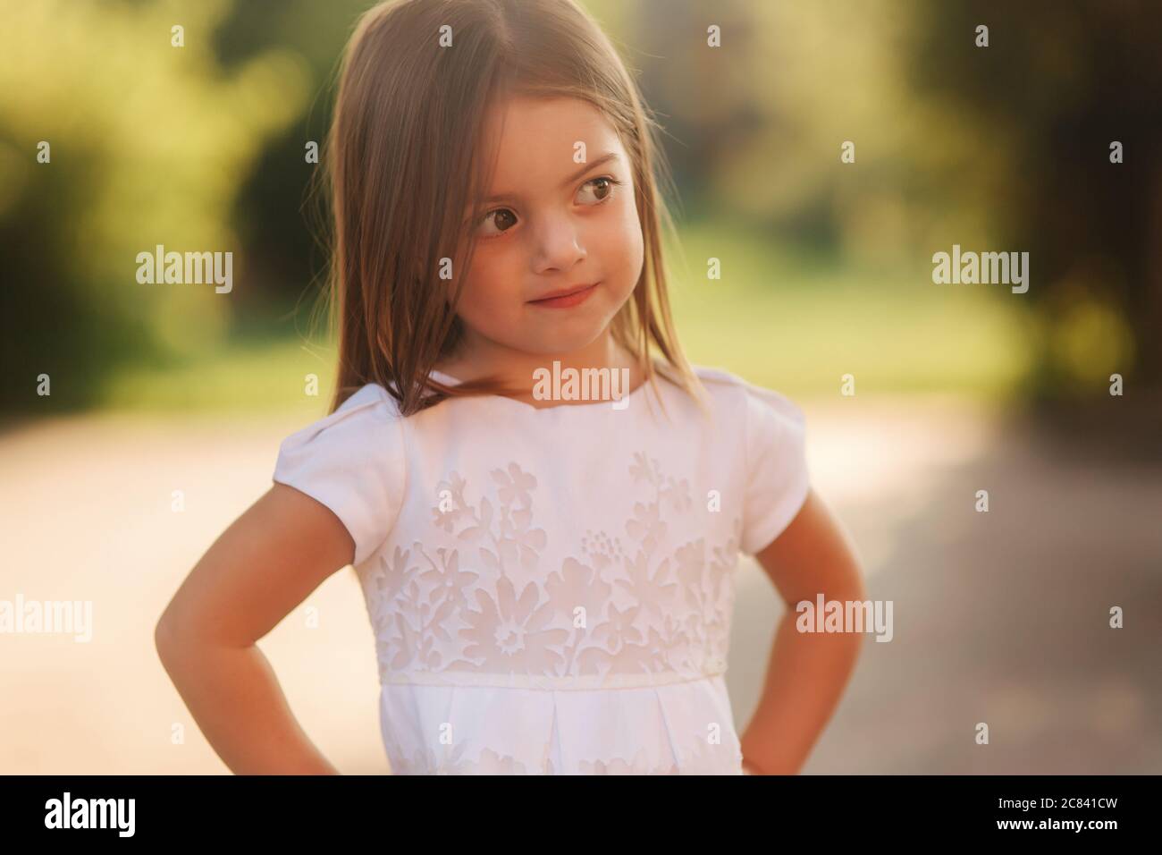 Portrait of happy smiled little girl in white dress Stock Photo - Alamy