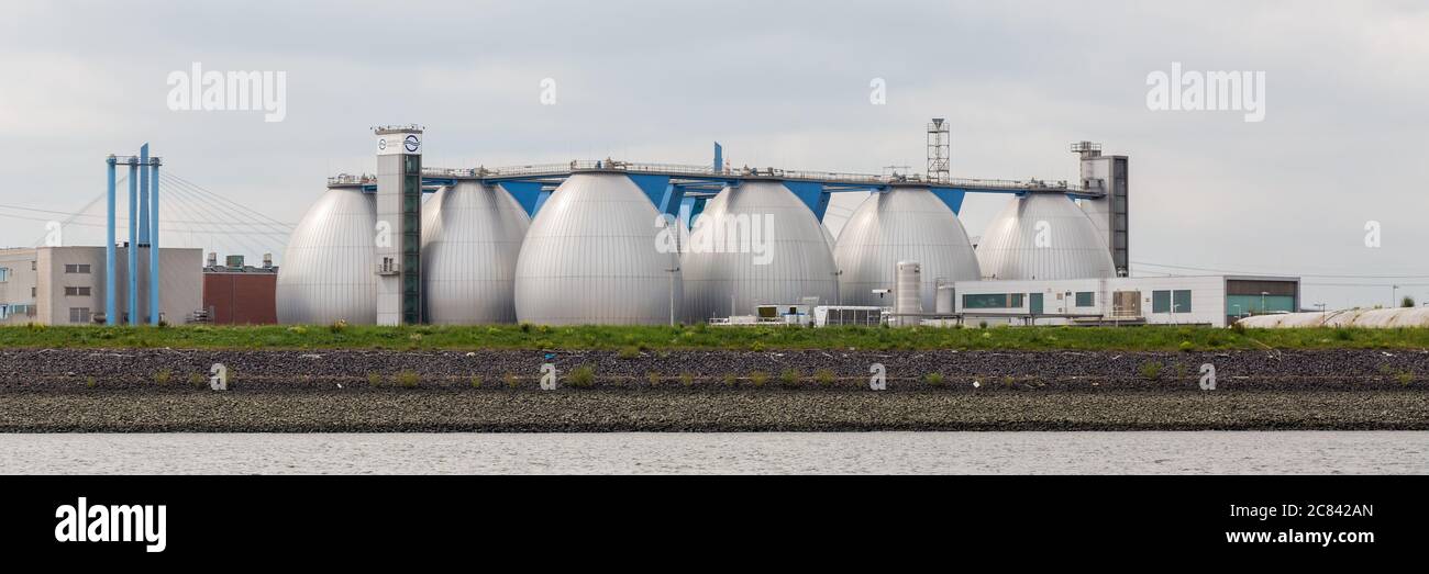 Panorama with large tanks. Belonging to a wastewater treatment plant located at the port of Hamburg. Stock Photo