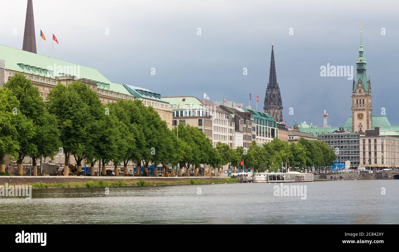 View towards the waterfront promenade at Ballindamm. With towers of the town hall and church St. Nikolai in the background. Stock Photo
