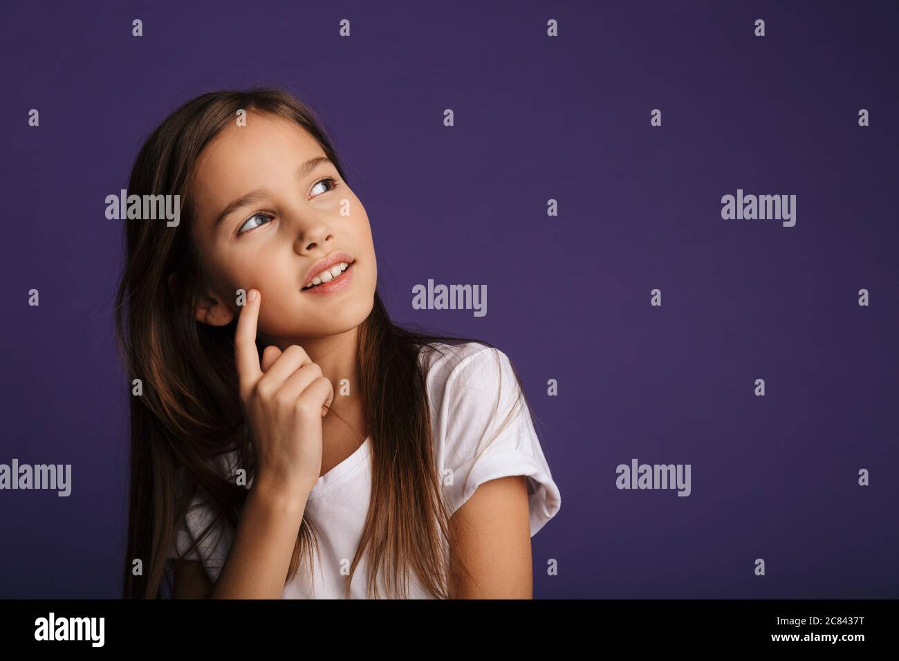 Photo of pleased beautiful girl posing and looking upward isolated over ...