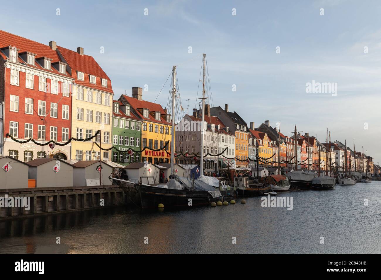 Copenhagen, Denmark - December 10, 2017: Nyhavn or New Harbour at sunny day, it is a 17th-century waterfront, canal and popular touristic destination Stock Photo