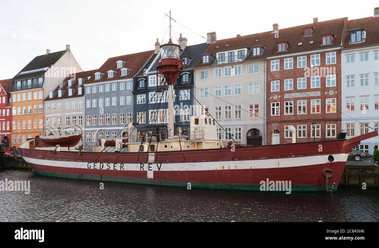 Copenhagen, Denmark - December 9, 2017: Street view of Nyhavn or New Harbour with moored Lightvessel No. XVII Gedser Rev. Ordinary people walk the str Stock Photo