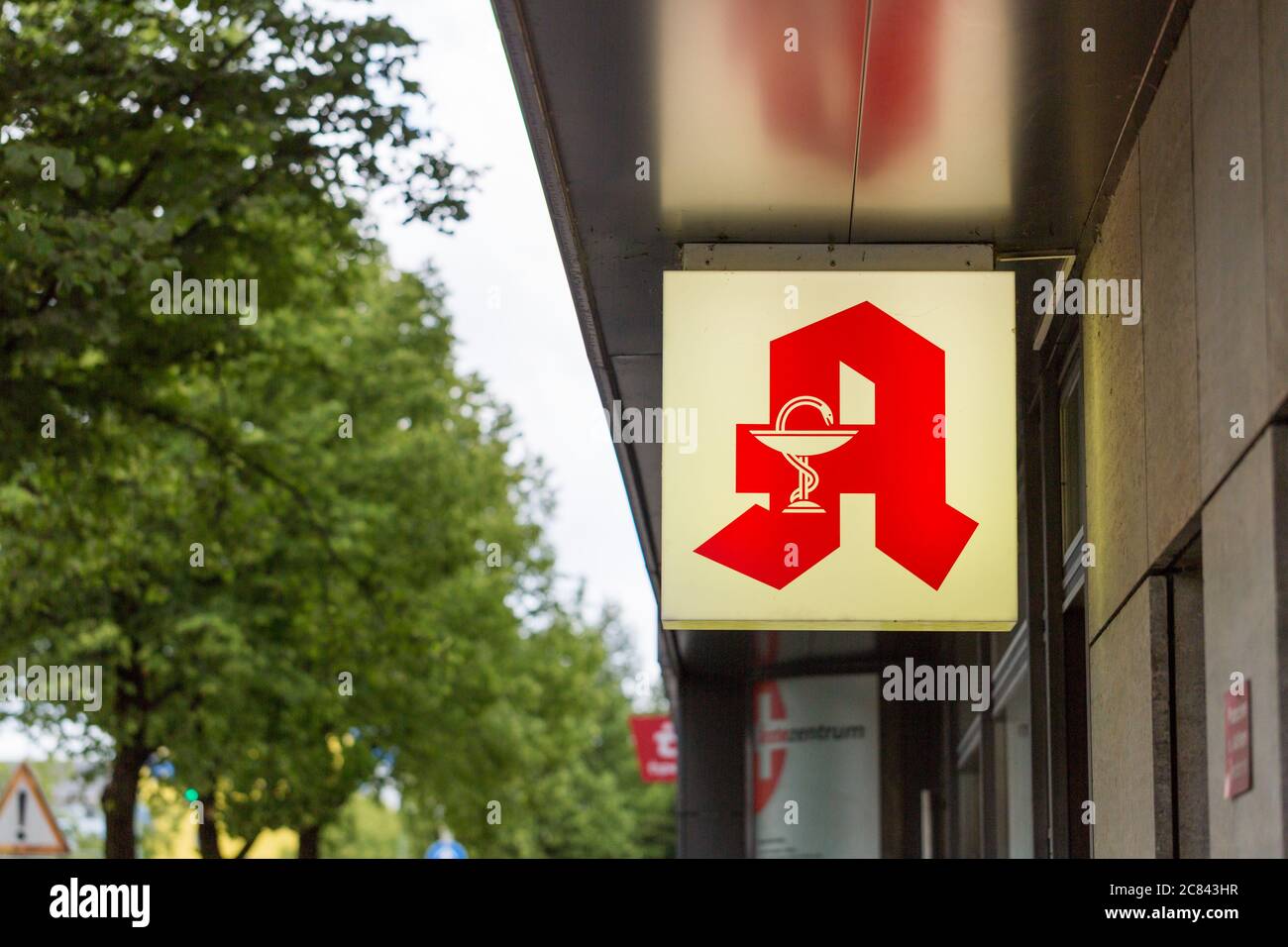 Munich, Bavaria / Germany - July 6, 2020: Illuminated pharmacy sign. Typical logo of a german 'Apotheke': A big red 'A' and the symbol of snake and ca Stock Photo