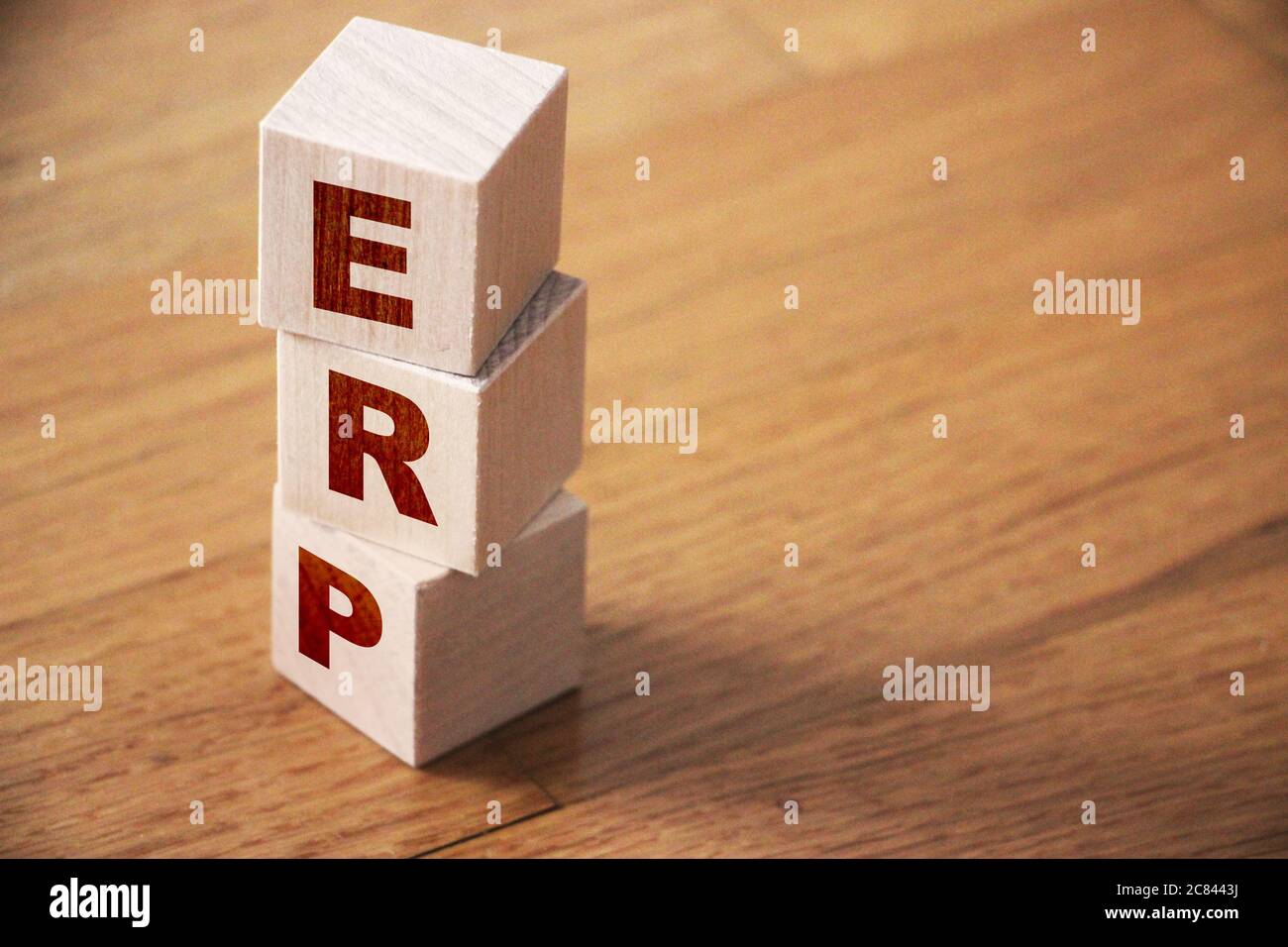 ERP abbreviation made of wooden cubes on wooden table. Business concept