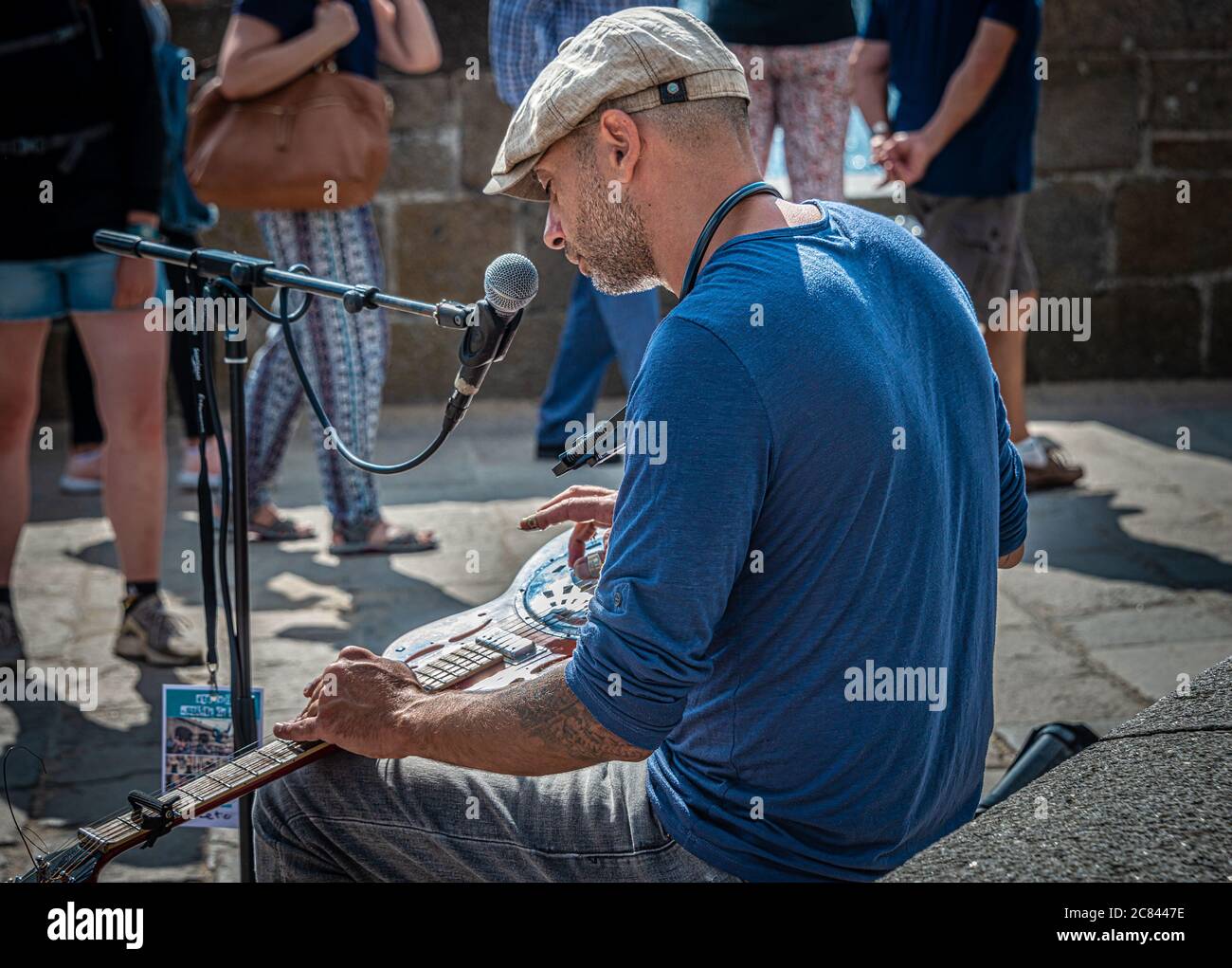 Man Playing Steel Guitar with Picks in the old town of Saint-Malo, France Stock Photo