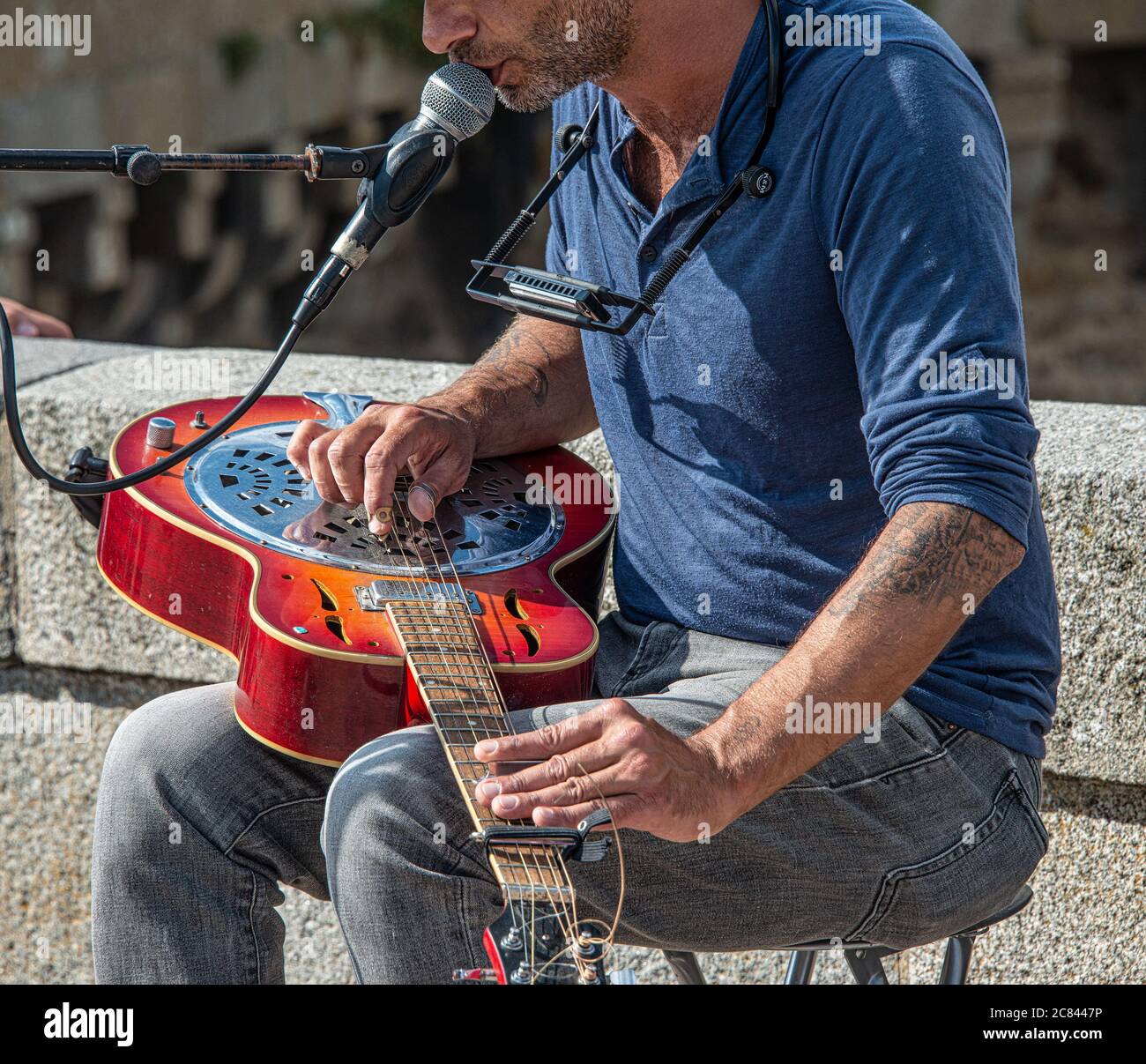 Man Playing Steel Guitar with Picks in the old town of Saint-Malo, France Stock Photo
