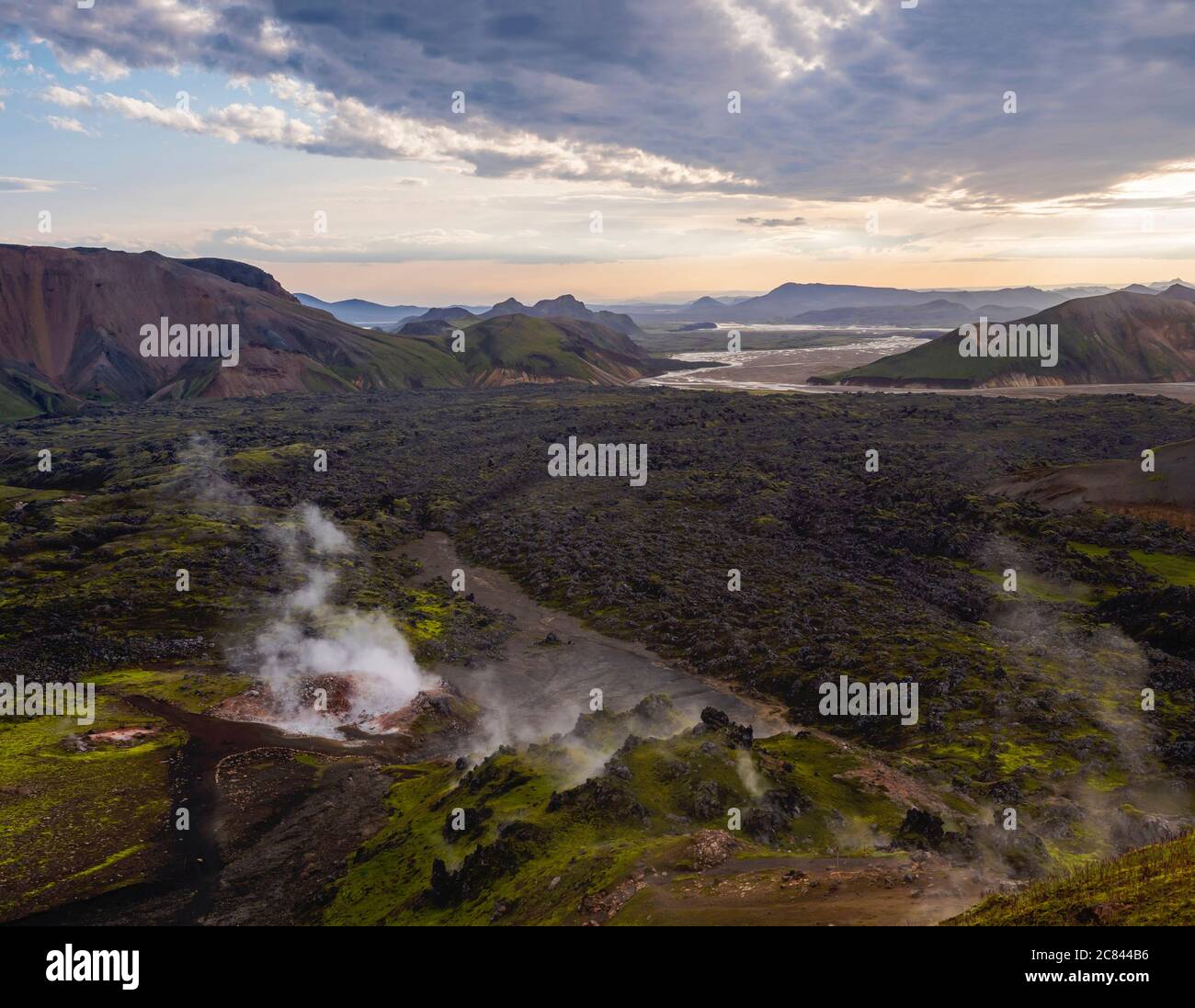 Colorful Rhyolit mountain panorma with multicolored volcanos and geothermal fumarole and river delta. Sunrise in Landmannalaugar at Fjallabak Nature Stock Photo