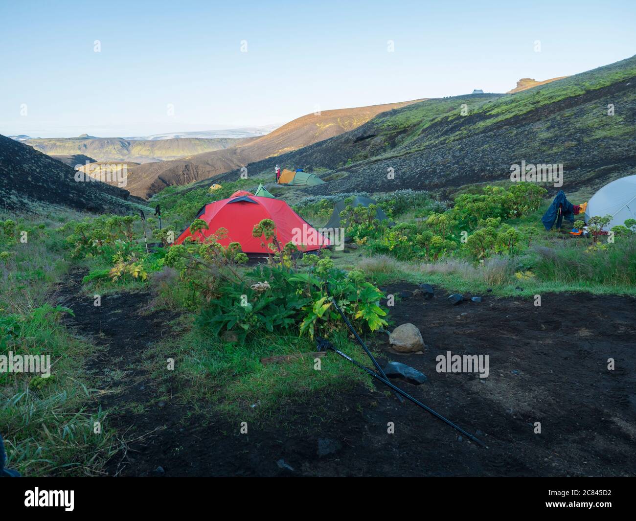 ICELAND, LANDMANNALAUGAR, August 2, 2019: Colorful tents in Botnar campsite at Iceland on Laugavegur hiking trail, green valley in volcanic landscape Stock Photo