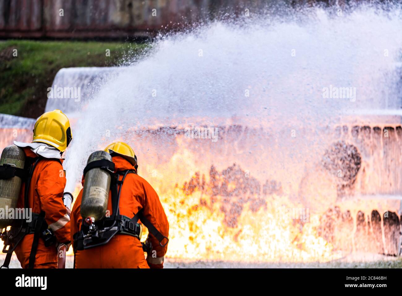 Firefighter using Chemical foam fire extinguisher to fighting with the fire flame from oil tanker truck accident. Firefighter safety disaster accident Stock Photo