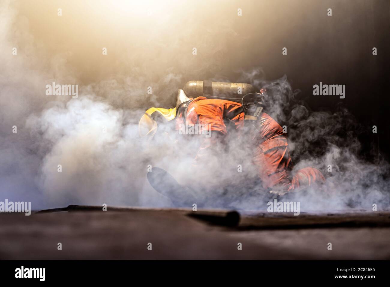 Firefighter check and rescue a man in building with smoke from fire inside. Firefighter safety rescue from accident and public service concept. Stock Photo