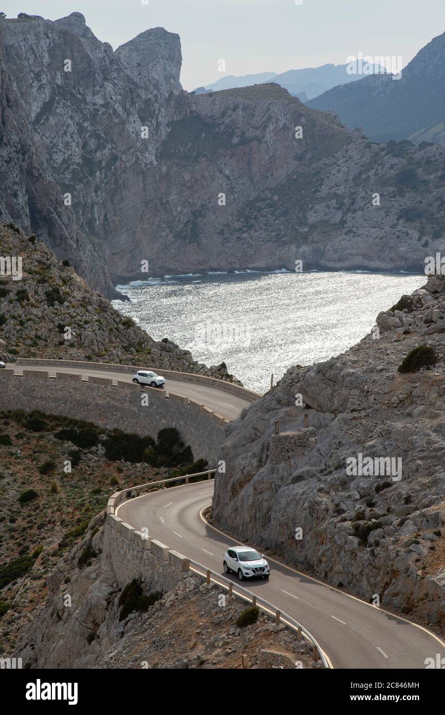 Cars on a road on Cap de Formentor with dramatic cliffs in background, Mallorca Stock Photo