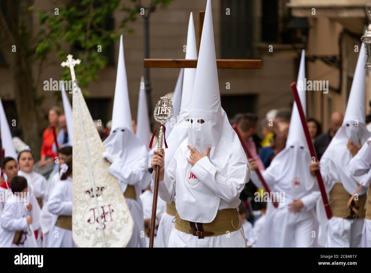 People dressed in religious white hoods of penance during the Easter parade in Palma, Mallorca Stock Photo