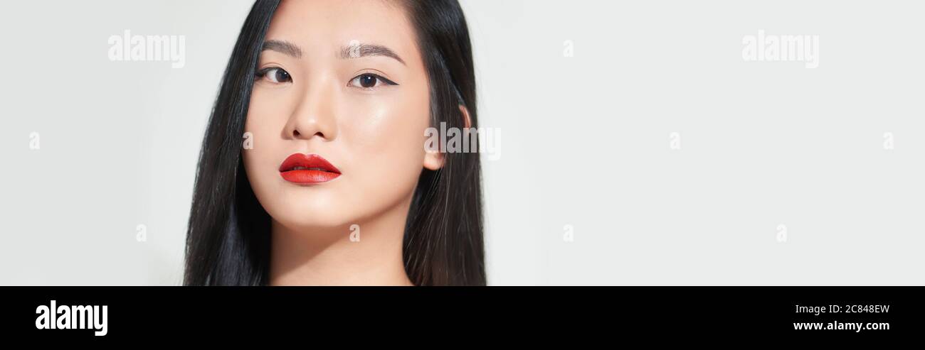 Beautiful woman asian face close up studio .She is catching hair Stock Photo
