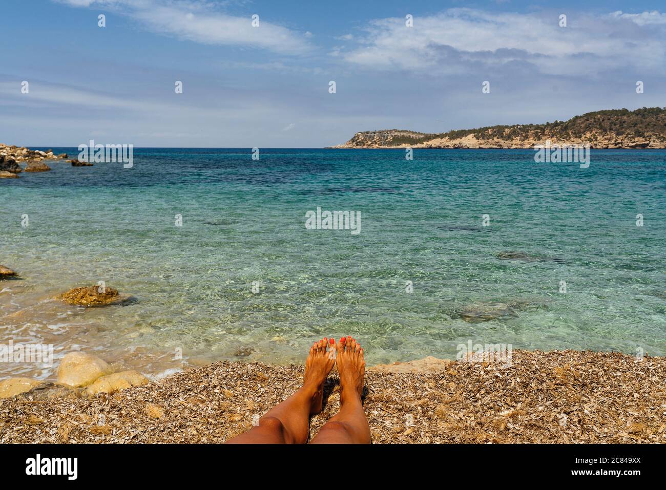 Woman feet in Cala Xarraca paradise in Ibiza, Balearic Islands Stock Photo