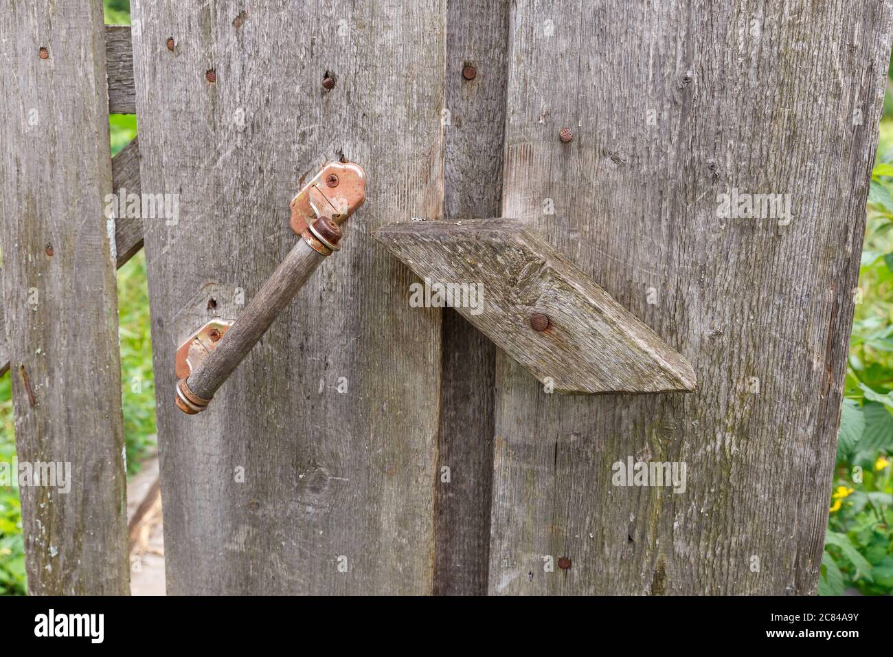 Wooden catch on the door to the kitchen garden. Stock Photo