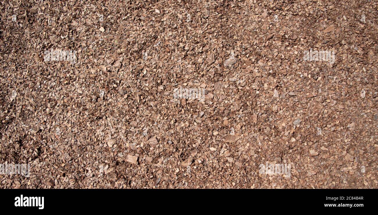 Background of seamless tiling wood chips used for safety in toddlers playgrounds. Stock Photo