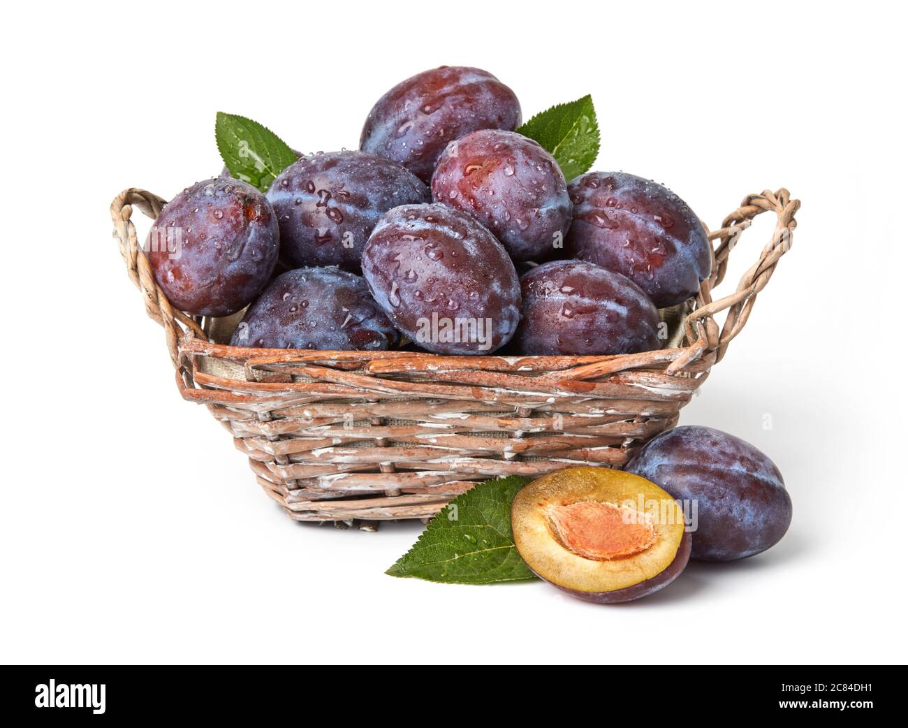 Fresh plums with leaves isolated on white Stock Photo