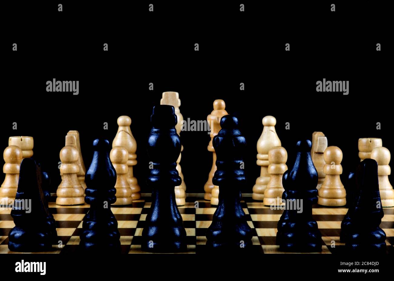 Lateral view of chess pieces on a wooden chess board Stock Photo