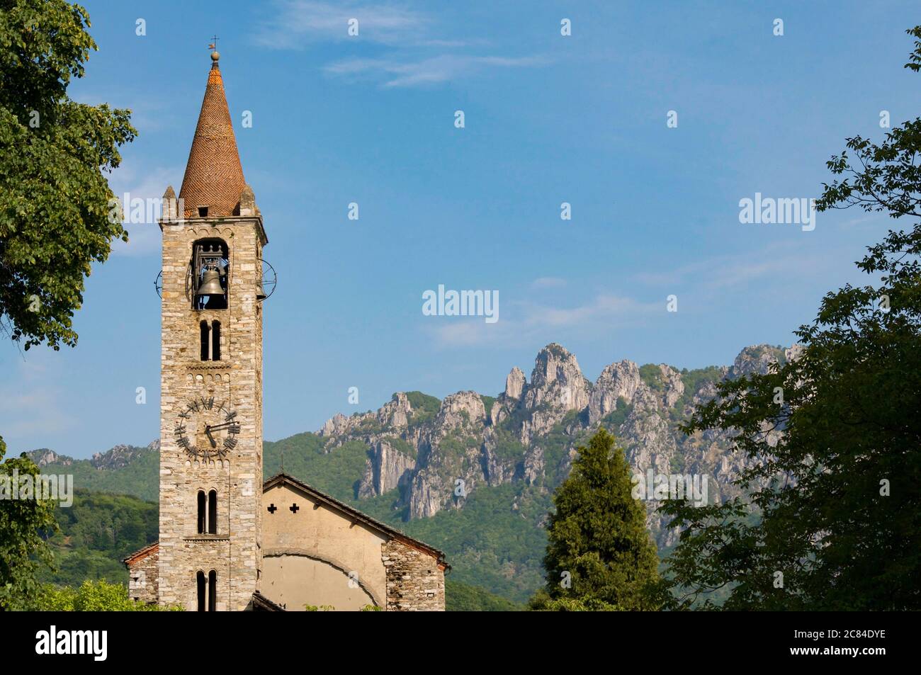 Scenic view of the Santo Stefano church of Tesserete with the Denti della Vecchia moutain range in the background Stock Photo