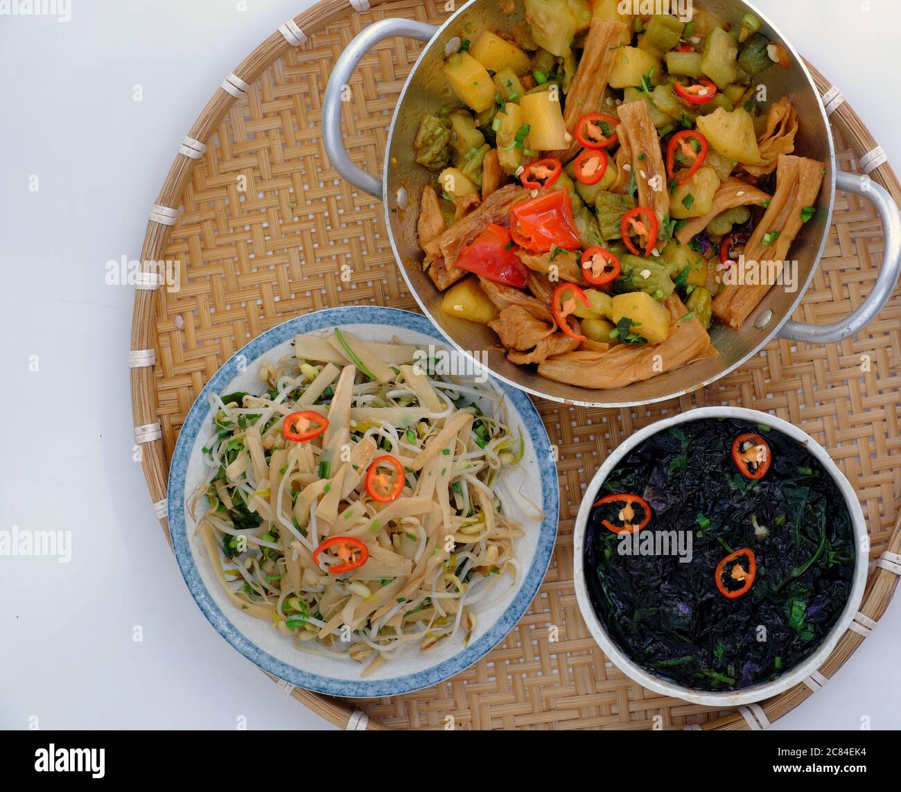 Top view daily meal, Vietnamese vegan food for vegetarian, tofu skin, pine apple and bitter melon cook with sauce, fried bamboo shoot, seaweed soup Stock Photo