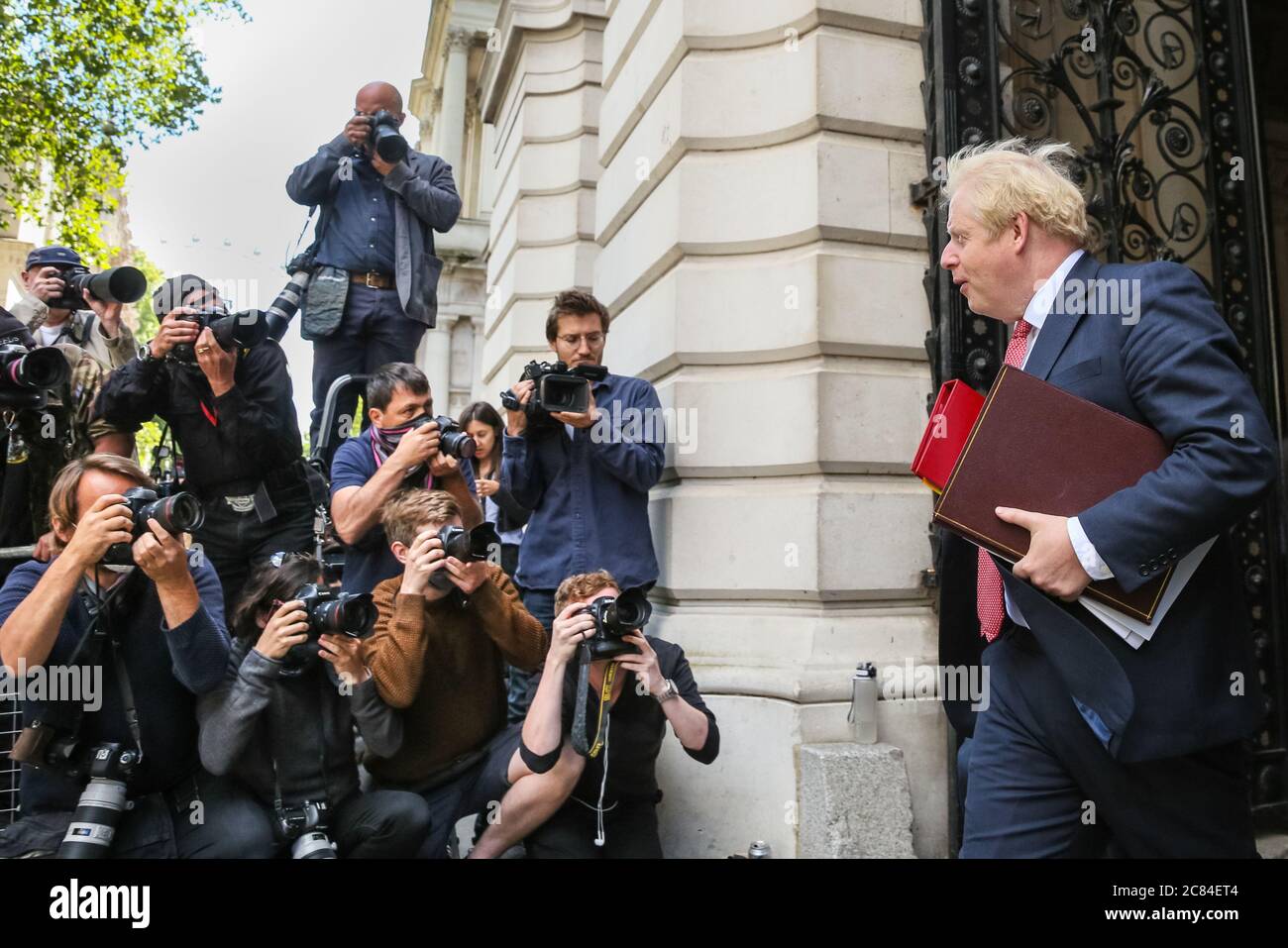 London, UK. 21st July, 2020. British Prime Minister Boris Johnson returns to 10 Downing Street after this mornings Cabinet Meeting, faced by press photographers. Credit: Imageplotter/Alamy Live News Stock Photo
