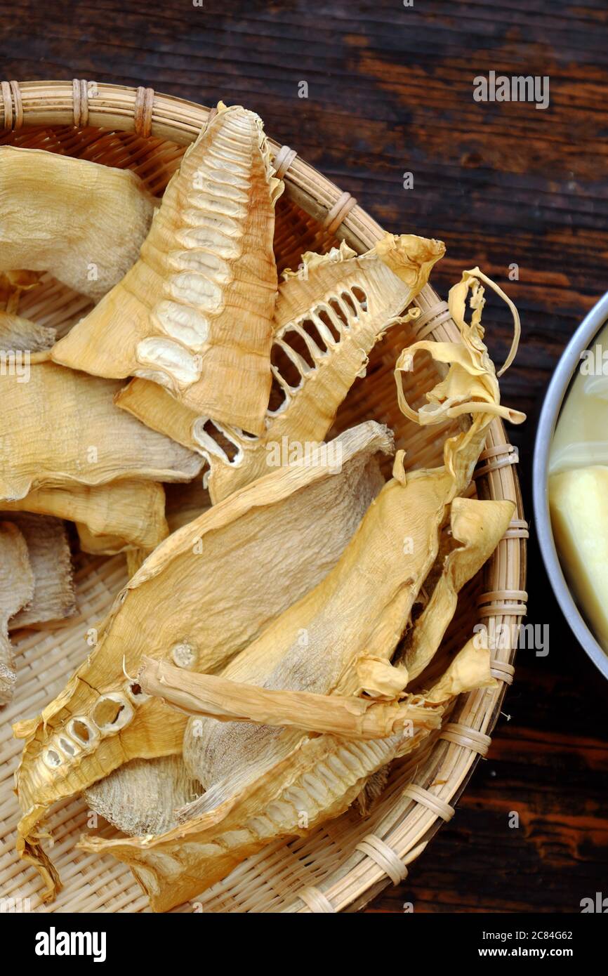 Top view dried bamboo shoots on wooden background, raw material for many Vietnamese vegan food Stock Photo