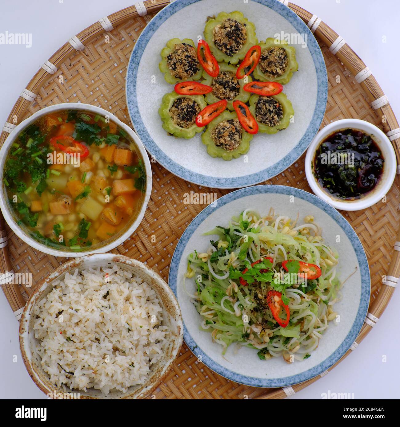 Top view tray of daily meal with dieting menu vegan food, nutrition, healthy dish with stuffed bitter melon with tofu, potato corn soup, fried chayote Stock Photo