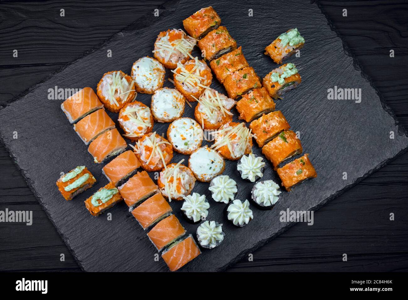 https://c8.alamy.com/comp/2C84H6K/appetizing-big-set-sushi-on-a-black-background-2C84H6K.jpg