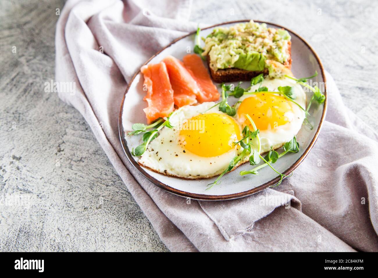 Egg breakfast. Healthy nutritious breakfast with eggs, salmon, avocado
