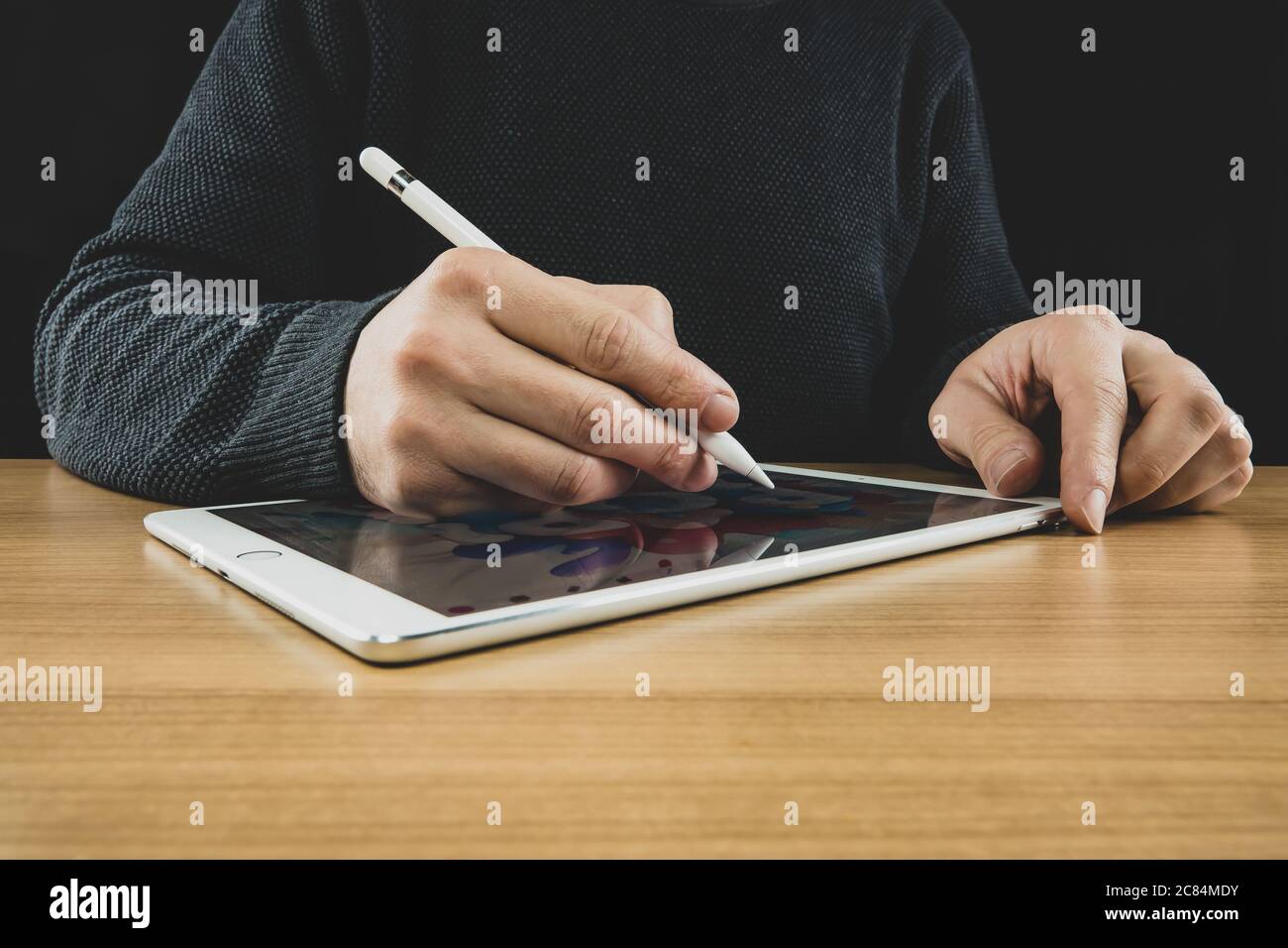 A man drawing illustration with Pencil and tablet. Stock Photo